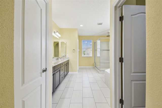 4089 Windcrest Dr, Wesley Chapel, FL 33544 - full bathroom featuring a shower stall, double vanity, tile patterned flooring, baseboards, and recessed lighting