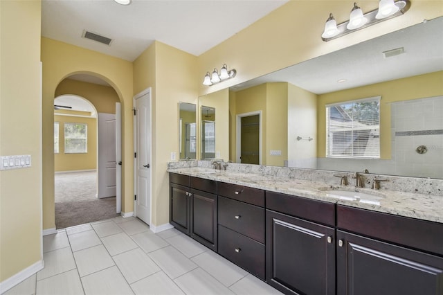 4089 Windcrest Dr, Wesley Chapel, FL 33544 - bathroom with double vanity, plenty of natural light, baseboards, and tile patterned floors