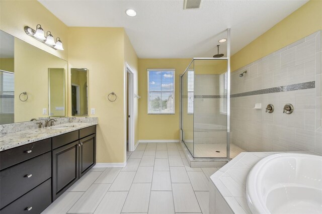 4089 Windcrest Dr, Wesley Chapel, FL 33544 - full bath with a shower stall, a bath, vanity, baseboards, and tile patterned flooring