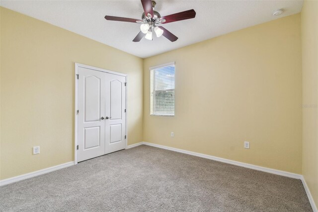4089 Windcrest Dr, Wesley Chapel, FL 33544 - unfurnished bedroom featuring carpet flooring, baseboards, and ceiling fan