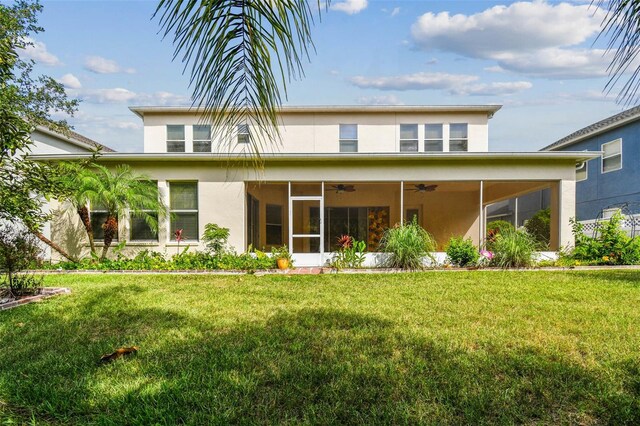 4089 Windcrest Dr, Wesley Chapel, FL 33544 - rear view of property featuring stucco siding, ceiling fan, a sunroom, and a lawn