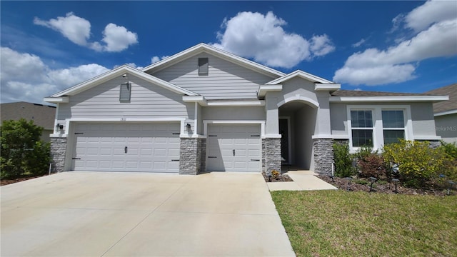 13111 Pepper Stem St, Spring Hill, FL 34609 - view of front facade featuring stone siding, concrete driveway, stucco siding, and an attached garage