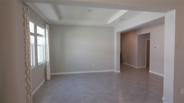 13111 Pepper Stem St, Spring Hill, FL 34609 - spare room featuring a raised ceiling and baseboards