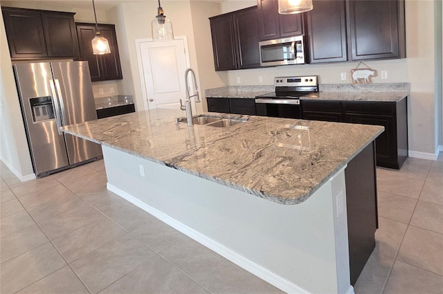 13111 Pepper Stem St, Spring Hill, FL 34609 - kitchen with stainless steel appliances, a sink, baseboards, and light tile patterned floors
