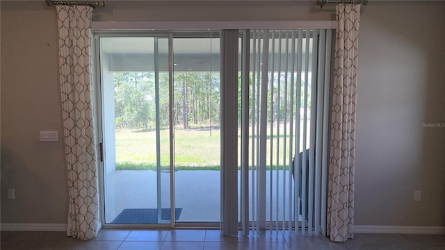 13111 Pepper Stem St, Spring Hill, FL 34609 - doorway with baseboards, plenty of natural light, and tile patterned floors