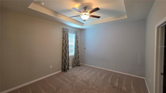 13111 Pepper Stem St, Spring Hill, FL 34609 - spare room featuring ceiling fan, a tray ceiling, carpet, a smoke detector, and baseboards