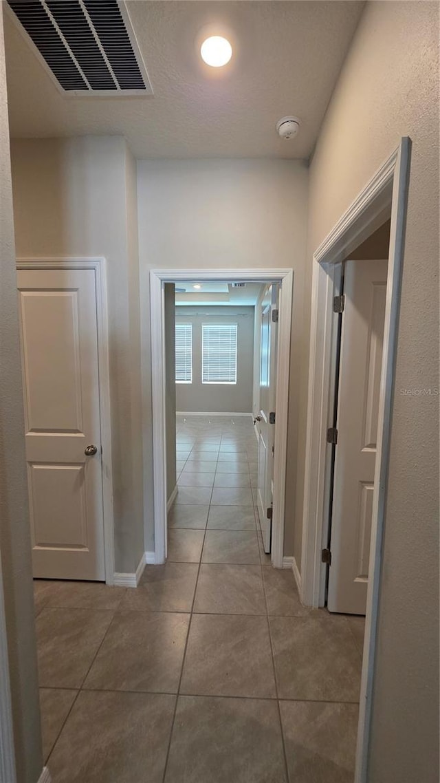 13111 Pepper Stem St, Spring Hill, FL 34609 - hall with tile patterned flooring and baseboards