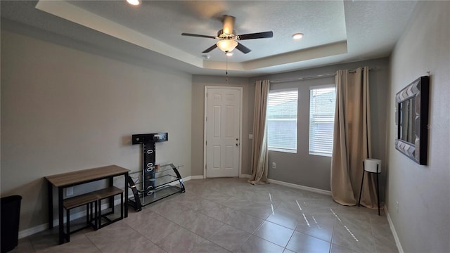 13111 Pepper Stem St, Spring Hill, FL 34609 - empty room with a raised ceiling, ceiling fan, and baseboards