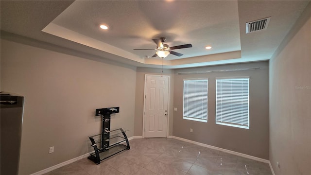 13111 Pepper Stem St, Spring Hill, FL 34609 - empty room featuring a tray ceiling, ceiling fan, baseboards, and recessed lighting