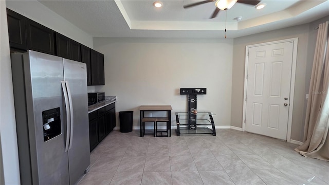 13111 Pepper Stem St, Spring Hill, FL 34609 - kitchen featuring stainless steel fridge, dark cabinetry, a raised ceiling, a ceiling fan, and light countertops