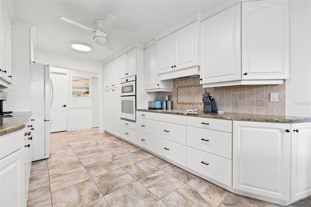 629 Fort Duquesna Dr, Sun City Center, FL 33573 - kitchen with a ceiling fan, white cabinetry, decorative backsplash, and white appliances