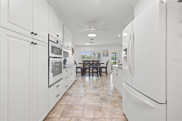 629 Fort Duquesna Dr, Sun City Center, FL 33573 - kitchen with white appliances, ceiling fan, and white cabinets