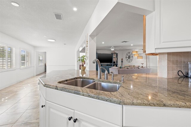 629 Fort Duquesna Dr, Sun City Center, FL 33573 - kitchen featuring a sink, light stone countertops, recessed lighting, a ceiling fan, and white cabinets