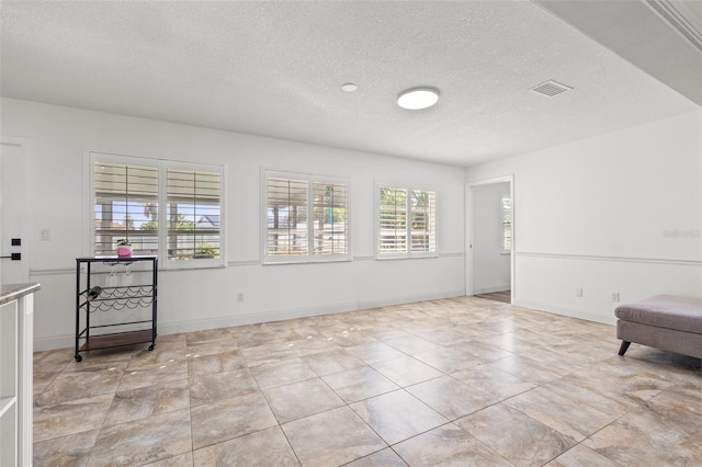 629 Fort Duquesna Dr, Sun City Center, FL 33573 - sitting room featuring a textured ceiling, baseboards, and light tile patterned flooring