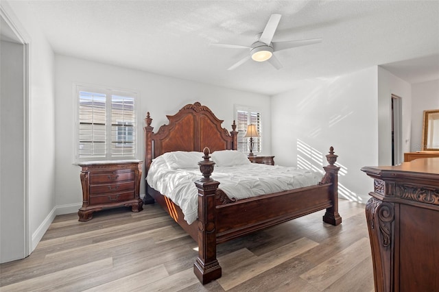 629 Fort Duquesna Dr, Sun City Center, FL 33573 - bedroom featuring multiple windows, light wood-type flooring, ceiling fan, and baseboards