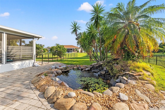 629 Fort Duquesna Dr, Sun City Center, FL 33573 - view of patio / terrace featuring a garden pond and a sunroom
