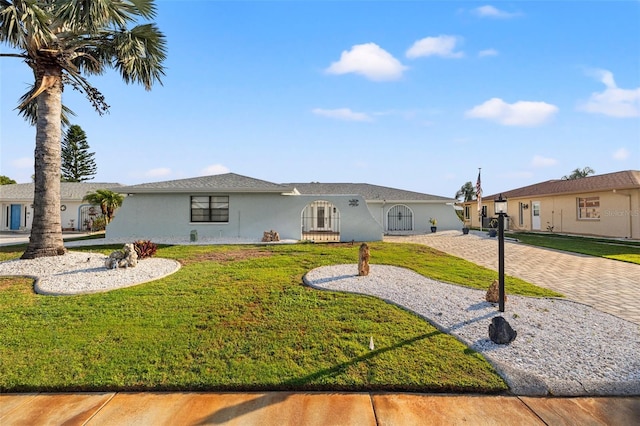 629 Fort Duquesna Dr, Sun City Center, FL 33573 - view of front of house with stucco siding and a front lawn