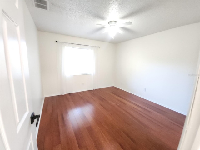 2935 Lichen Ln Unit D, Clearwater, FL 33760 - unfurnished room featuring wood finished floors, a textured ceiling, and ceiling fan
