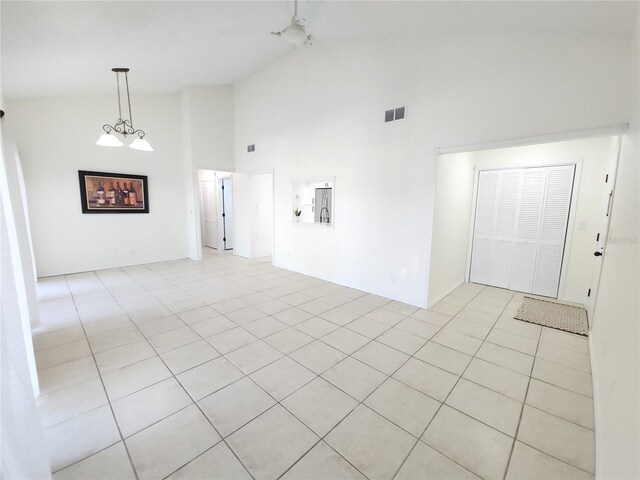 2935 Lichen Ln Unit D, Clearwater, FL 33760 - empty room featuring high vaulted ceiling and light tile patterned floors