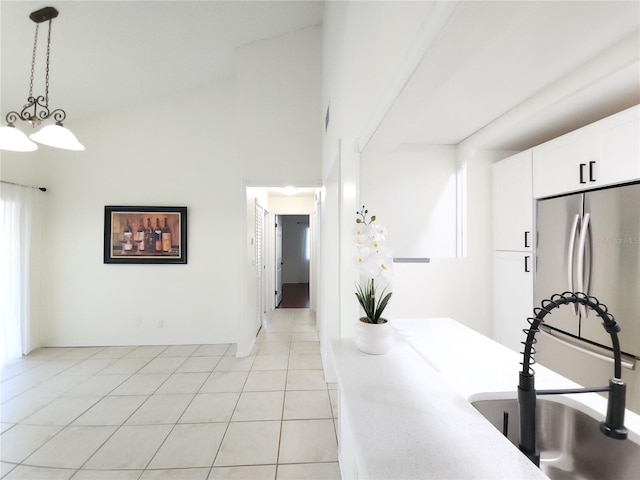 2935 Lichen Ln Unit D, Clearwater, FL 33760 - kitchen with freestanding refrigerator, pendant lighting, white cabinets, light countertops, and light tile patterned flooring