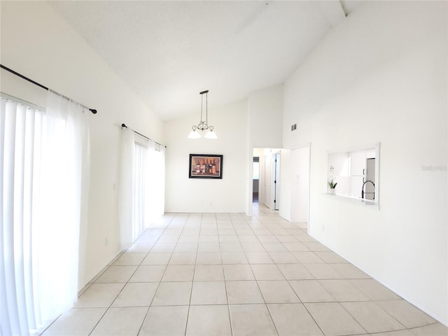 2935 Lichen Ln Unit D, Clearwater, FL 33760 - spare room with high vaulted ceiling and light tile patterned flooring