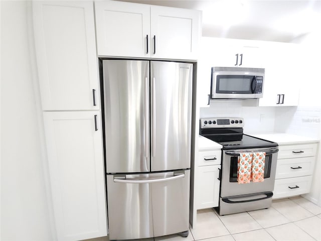 2935 Lichen Ln Unit D, Clearwater, FL 33760 - kitchen with appliances with stainless steel finishes, white cabinets, light countertops, and light tile patterned floors