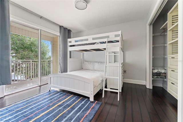 512 1st St Unit 108, Indian Rocks Beach, FL 33785 - bedroom with baseboards, hardwood / wood-style flooring, and access to exterior
