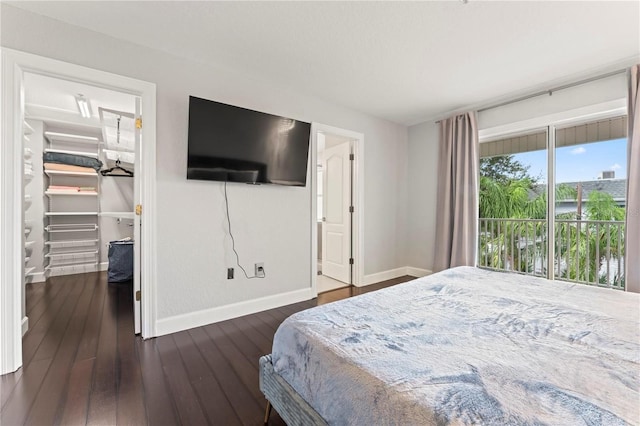 512 1st St Unit 108, Indian Rocks Beach, FL 33785 - bedroom with baseboards, a spacious closet, and dark wood-type flooring