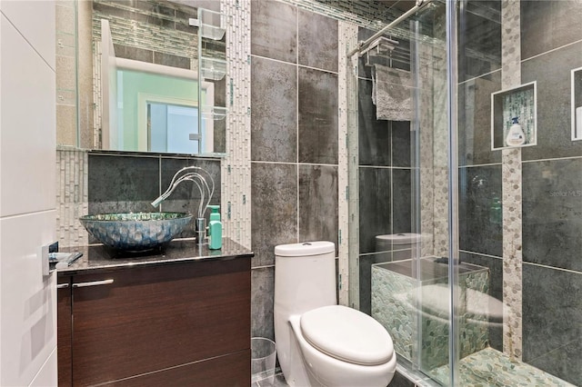 512 1st St Unit 108, Indian Rocks Beach, FL 33785 - full bathroom featuring tile walls, vanity, a shower stall, and toilet
