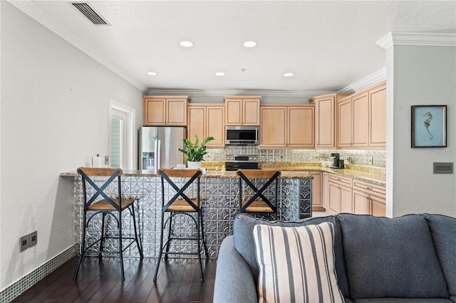 512 1st St Unit 108, Indian Rocks Beach, FL 33785 - kitchen with appliances with stainless steel finishes, ornamental molding, dark wood-type flooring, light brown cabinetry, and backsplash