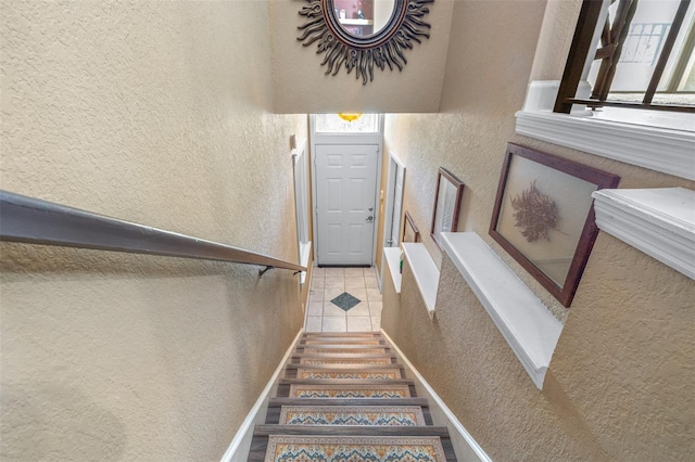 731 Cruise View Dr, Tampa, FL 33602 - staircase with a textured wall and tile patterned floors