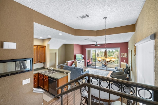 731 Cruise View Dr, Tampa, FL 33602 - kitchen featuring a textured wall, a sink, a textured ceiling, open floor plan, and dishwashing machine