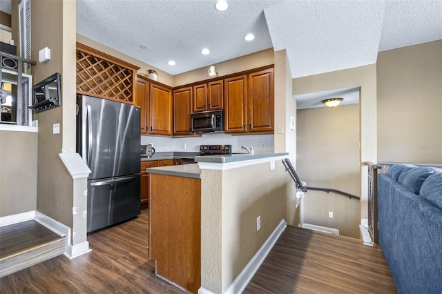 731 Cruise View Dr, Tampa, FL 33602 - kitchen featuring freestanding refrigerator, baseboards, dark wood-style floors, a peninsula, and a textured ceiling