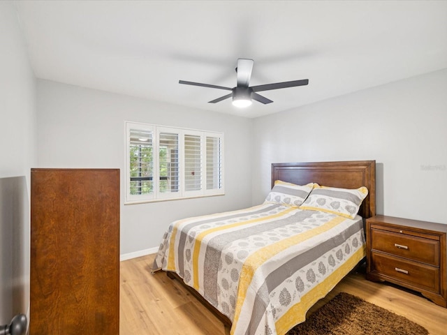 3062 Eastland Blvd Unit 405, Clearwater, FL 33761 - bedroom with light wood finished floors, a ceiling fan, and baseboards