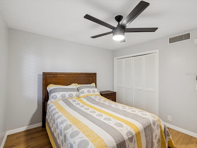 3062 Eastland Blvd Unit 405, Clearwater, FL 33761 - bedroom featuring wood finished floors, a closet, baseboards, and ceiling fan
