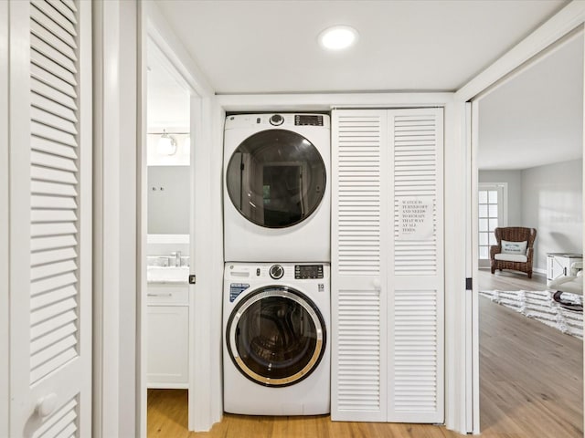 3062 Eastland Blvd Unit 405, Clearwater, FL 33761 - laundry area featuring estacked washer and dryer and light wood-type flooring