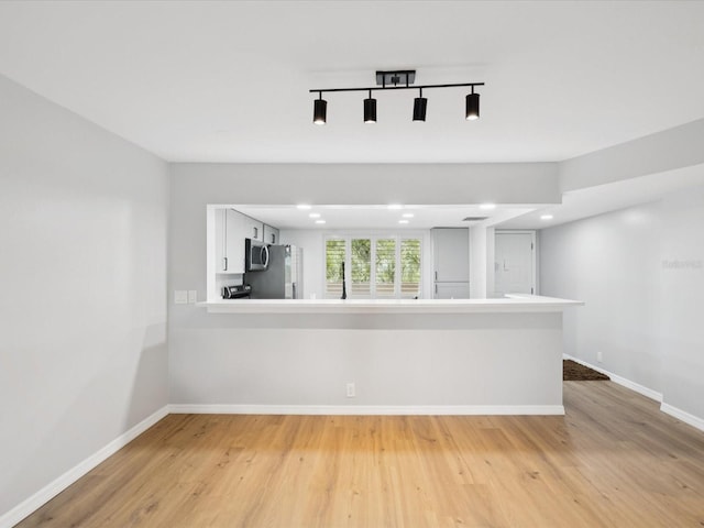 3062 Eastland Blvd Unit 405, Clearwater, FL 33761 - empty room featuring baseboards, light wood finished floors, and recessed lighting