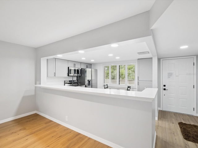 3062 Eastland Blvd Unit 405, Clearwater, FL 33761 - kitchen featuring appliances with stainless steel finishes, light wood-type flooring, light countertops, recessed lighting, and baseboards