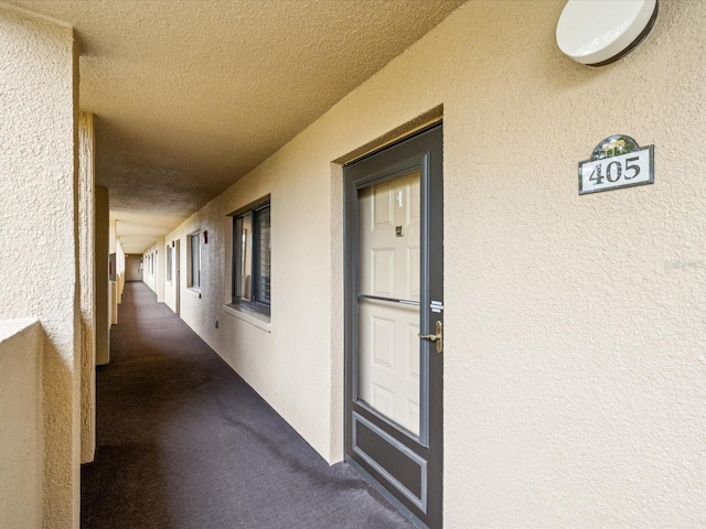 3062 Eastland Blvd Unit 405, Clearwater, FL 33761 - doorway to property with stucco siding and a balcony