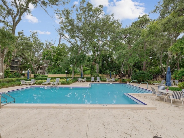 3062 Eastland Blvd Unit 405, Clearwater, FL 33761 - community pool featuring a patio area and view of scattered trees
