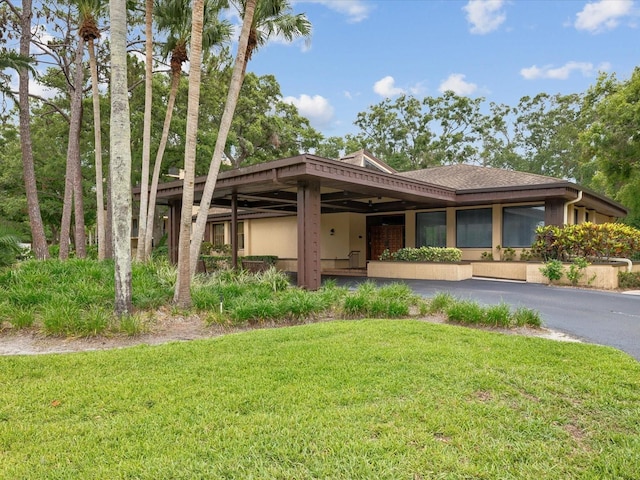 3062 Eastland Blvd Unit 405, Clearwater, FL 33761 - view of front of home featuring a front lawn, stucco siding, and a shingled roof