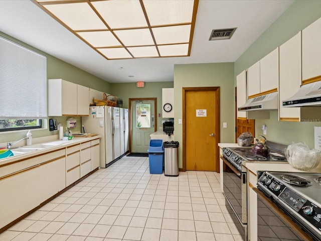3062 Eastland Blvd Unit 405, Clearwater, FL 33761 - kitchen with freestanding refrigerator, under cabinet range hood, light countertops, range with electric stovetop, and extractor fan