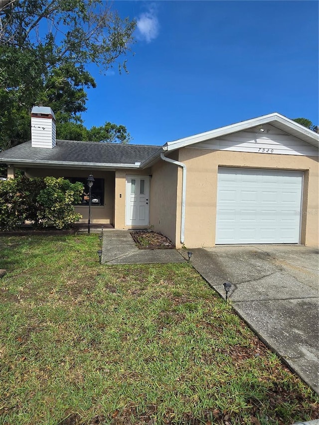 7920 52nd St N, Pinellas Park, FL 33781 - ranch-style home with concrete driveway, stucco siding, a garage, a front lawn, and a chimney