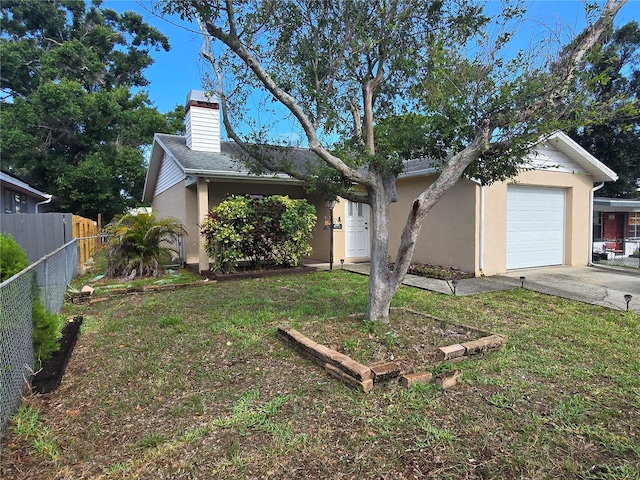 7920 52nd St N, Pinellas Park, FL 33781 - view of front of house with concrete driveway, a chimney, stucco siding, and a garage
