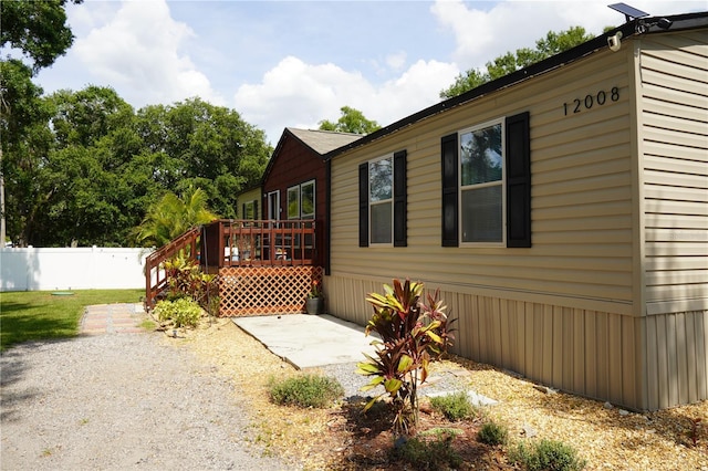12008 Rose Ln, Riverview, FL 33569 - view of side of home with a deck and a patio area