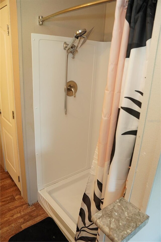 12008 Rose Ln, Riverview, FL 33569 - full bath featuring curtained shower and wood finished floors