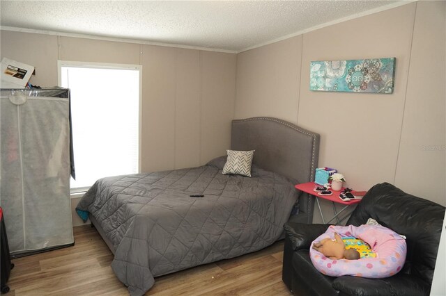 12008 Rose Ln, Riverview, FL 33569 - bedroom with crown molding, wood finished floors, and a textured ceiling