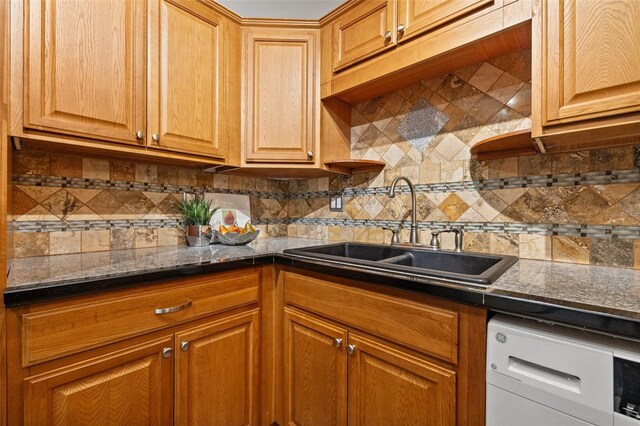 232 36th Ave N Unit 202C, Saint Petersburg, FL 33704 - kitchen featuring a sink, dark countertops, tasteful backsplash, and brown cabinets
