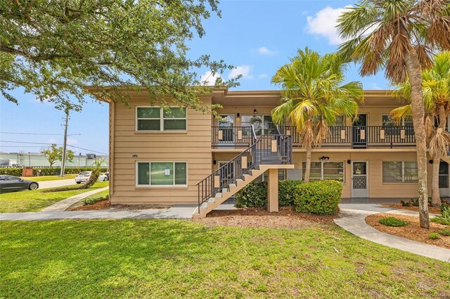 232 36th Ave N Unit 202C, Saint Petersburg, FL 33704 - view of front of house with stairway and a front lawn