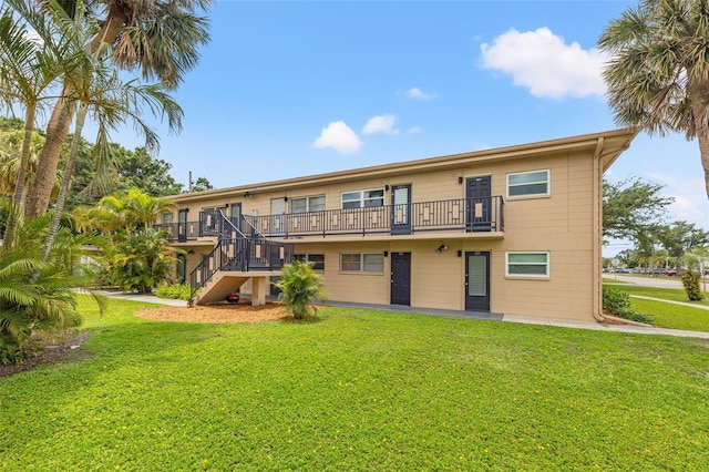 232 36th Ave N Unit 202C, Saint Petersburg, FL 33704 - back of house with a lawn, a balcony, and stairs